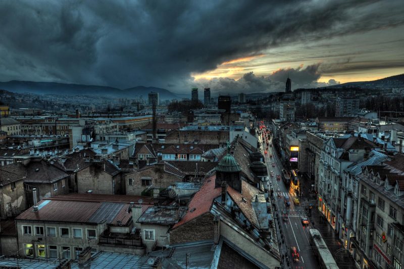 The city of Sarajevo, capital of Bosnia and Herzegovina, is situated on the Miljacka River, surrounded by the Dinaric Alps.