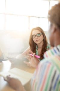 Unposed group of creative business people in an open concept office brainstorming their next project.