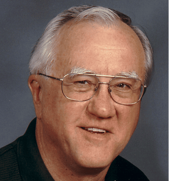 Elderly man with glasses smiling, representing faithful innovation in mission work.