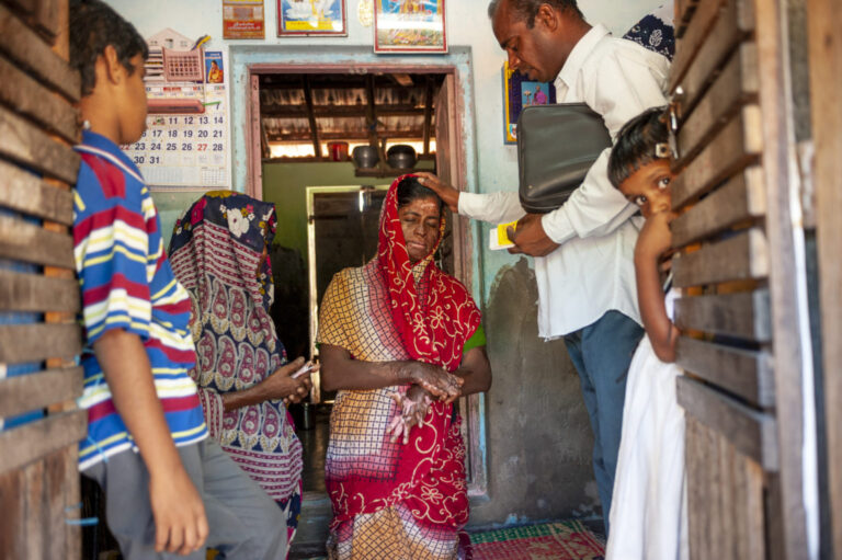 Community members engaged in holistic ministry activities in a rural setting.