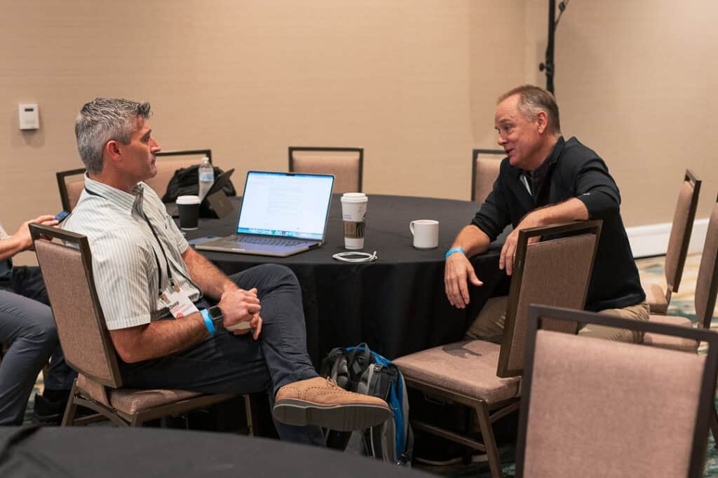 Two men engaged in conversation at Missio Nexus conference.