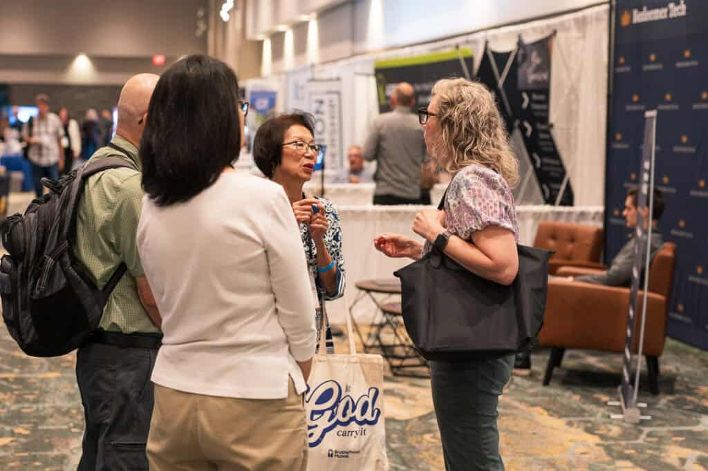 Group of diverse professionals engaging in conversation at Missio Nexus event.