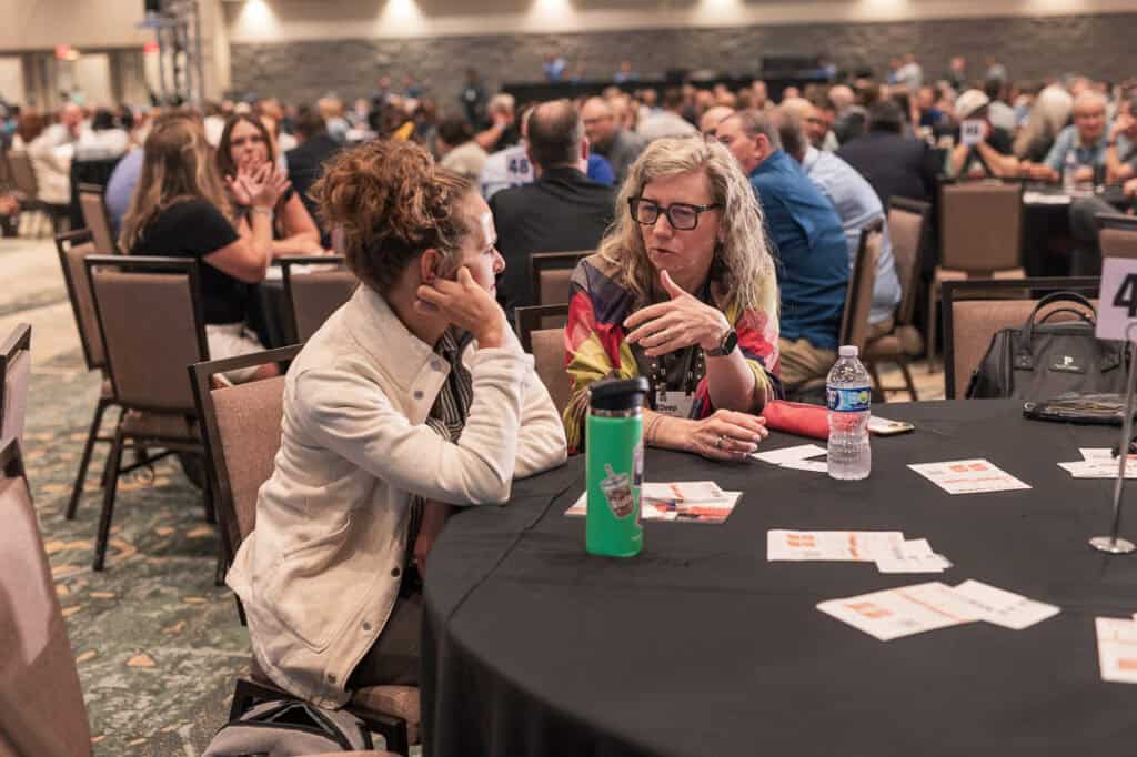 Attendees engaging in conversation at Missio Nexus conference.