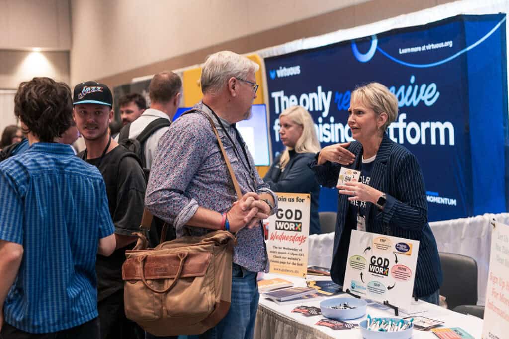 Attendees engaging at Missio Nexus conference booth in a professional setting.