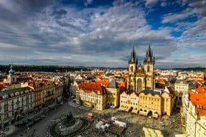 Panoramic view of Prague's Old Town Square with historic buildings and the Church of Our Lady before.