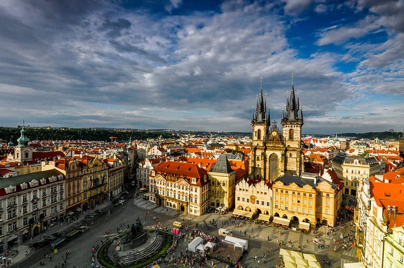Panoramic view of Prague's Old Town Square with historic buildings and the Church of Our Lady before.