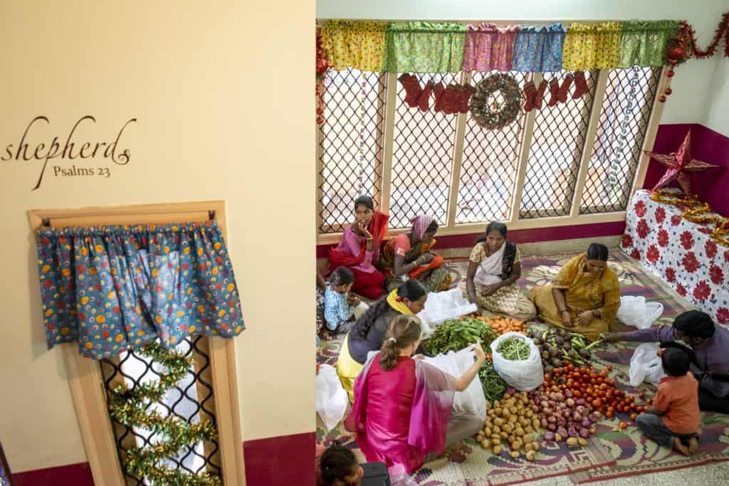 Women and children gather for a cultural or community event indoors.
